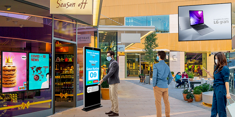 People looking Their Queue Number Details In The Digital Signage